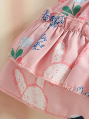 Pink baby set with bunny and floral print, featuring ruffles and bow detail.