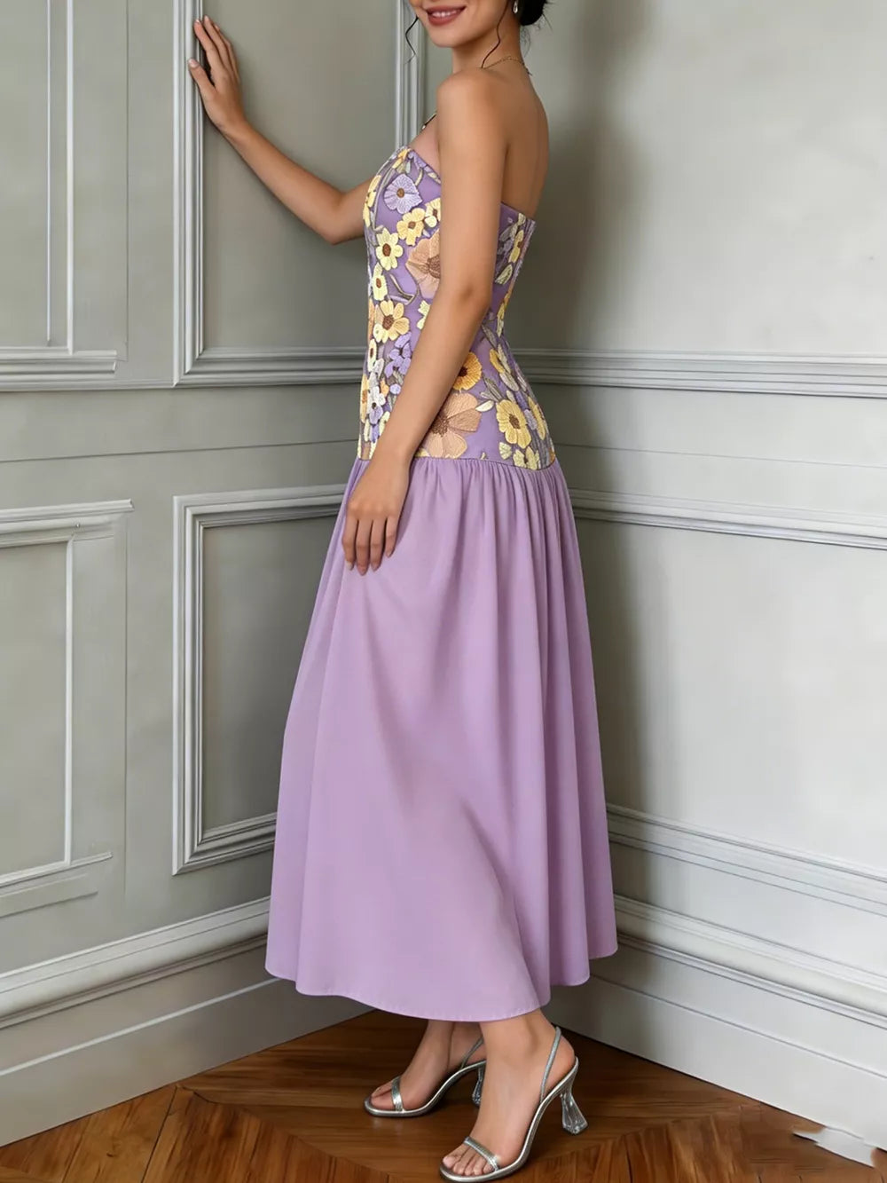 Strapless maxi dress in lavender with a floral embroidered bodice and tiered skirt.