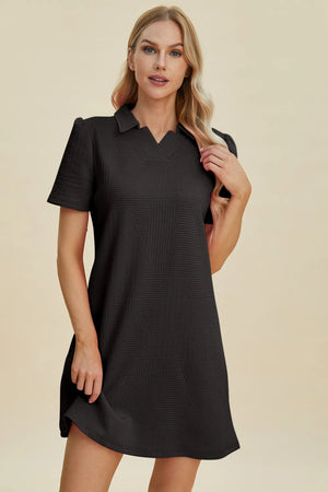 Black textured V-neck short sleeve mini dress with geometric pattern