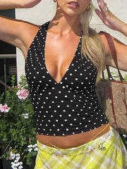 Black polka dot halter cami with deep V-neck and ruched detail.