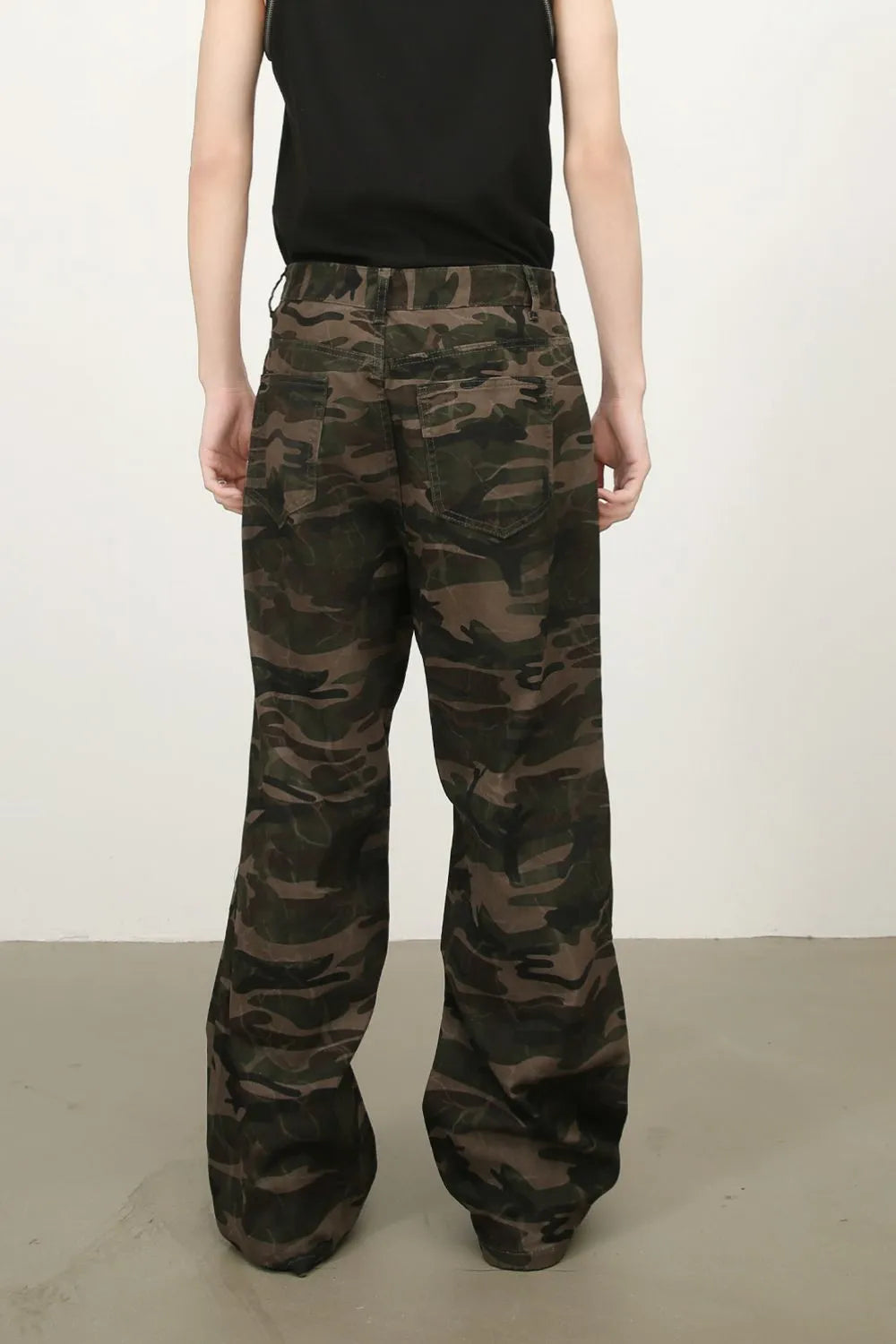 Camo wide-leg utility trousers in green camouflage with cargo pockets.