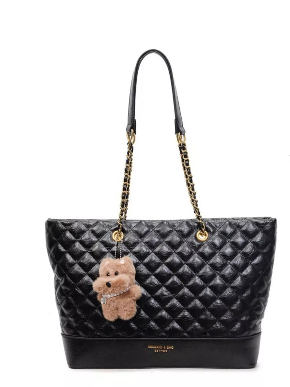 Black quilted shoulder bag with chain straps and a fluffy teddy bear charm.