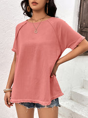 Coral raglan sleeve tee with fringed hem and neckline detail.