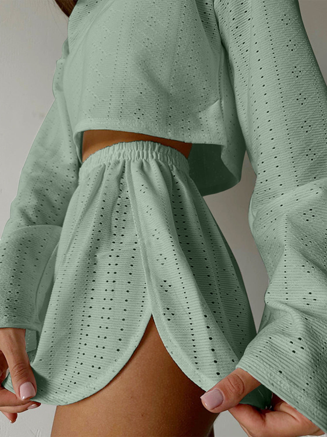 Perforated crop top and shorts set in matcha green with wide sleeves and a high-waisted skirt.