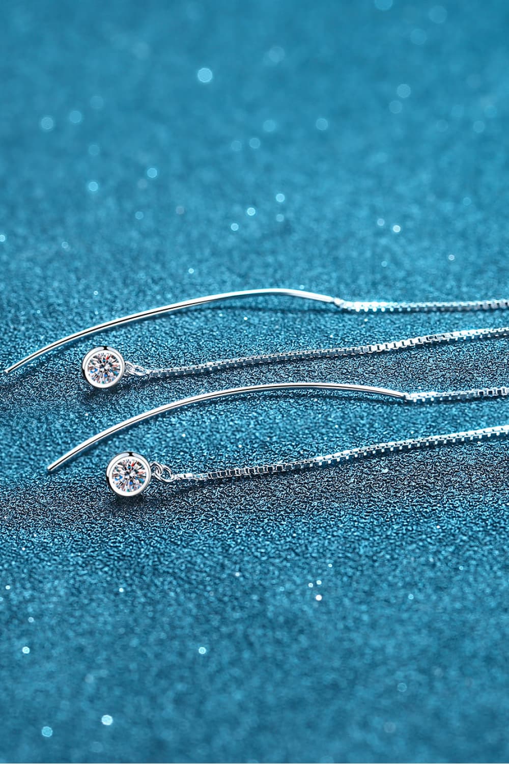 Silver cascading moissanite threader earrings with box chain detail.