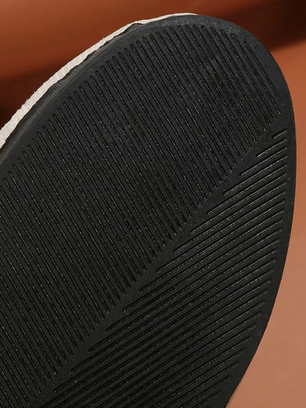 Embellished suede ballet flats with a textured black sole.