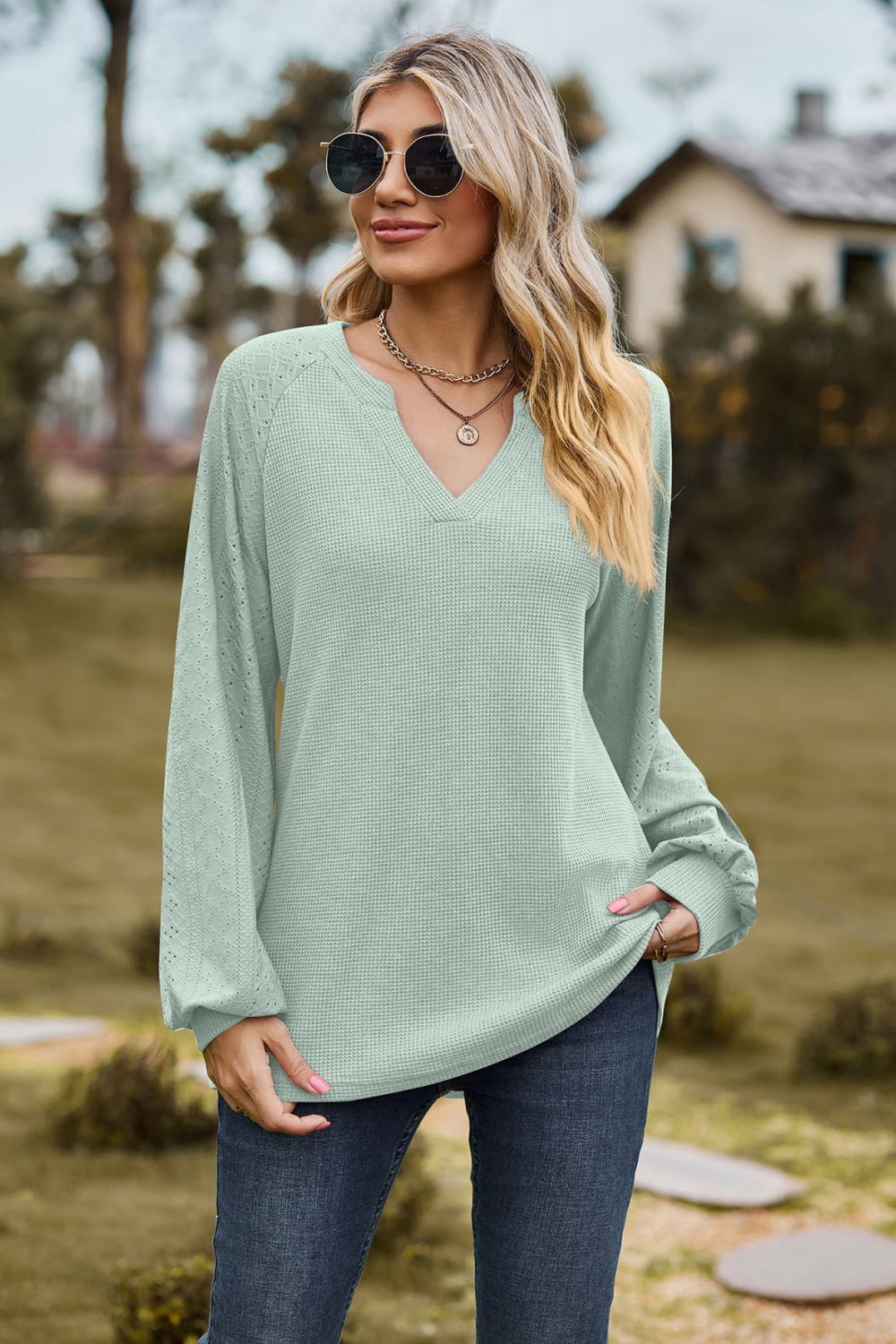 Light green waffle knit raglan top with laser cut sleeves and v-neck