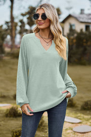 Light green waffle knit raglan top with laser cut sleeves and v-neck
