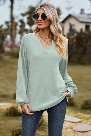 Light green waffle knit raglan top with laser cut sleeves and v-neck