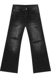 Distressed flare jeans in dark bleach wash denim with ripped details.