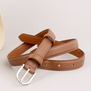 Skinny caramel leather belt with silver buckle and stitched details.