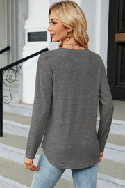 Dark Gray long sleeve top with curved hem and side button detail.