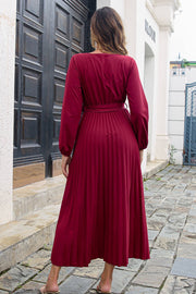 Wine pleated maxi dress with long sleeves and wrap-tie waist.