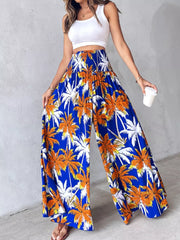 Bohemian print wide leg pants in royal blue with smocked waist and palm tree pattern