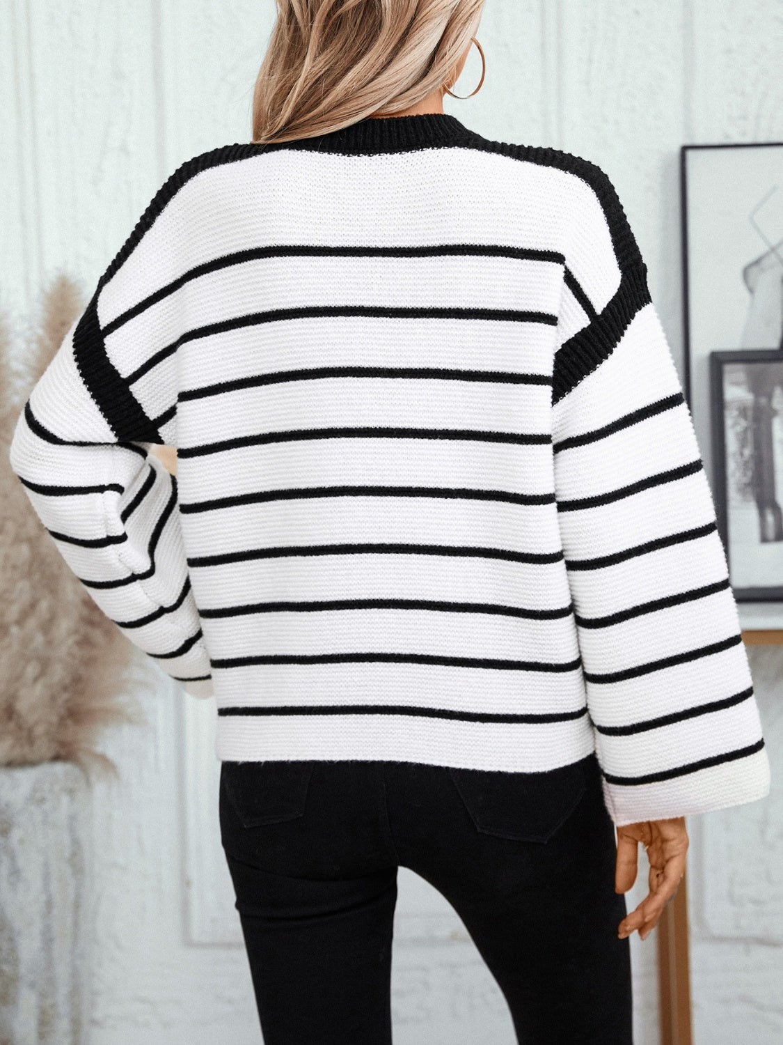 Contrast stripe knit sweater with wide sleeves and black trim.