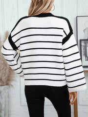 Contrast stripe knit sweater with wide sleeves and black trim.