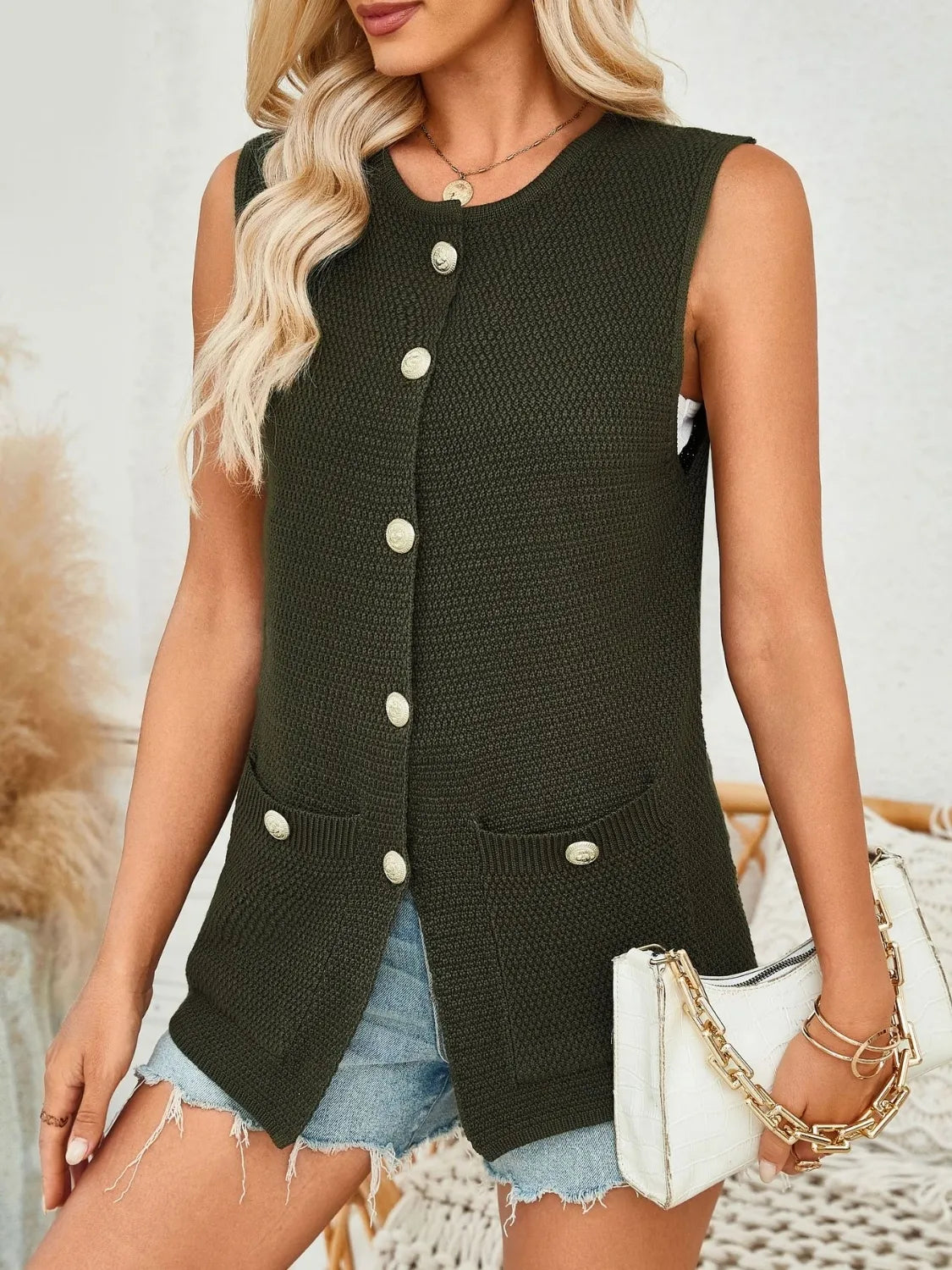 Buttoned knit vest in Black Forest with gold buttons and patch pockets.