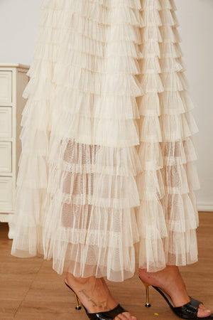Tiered tulle maxi skirt in ivory with ruffled layers.