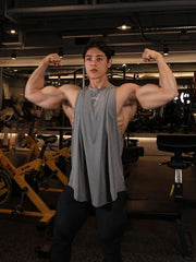 Gray performance tank top with subtle branding and a relaxed fit.