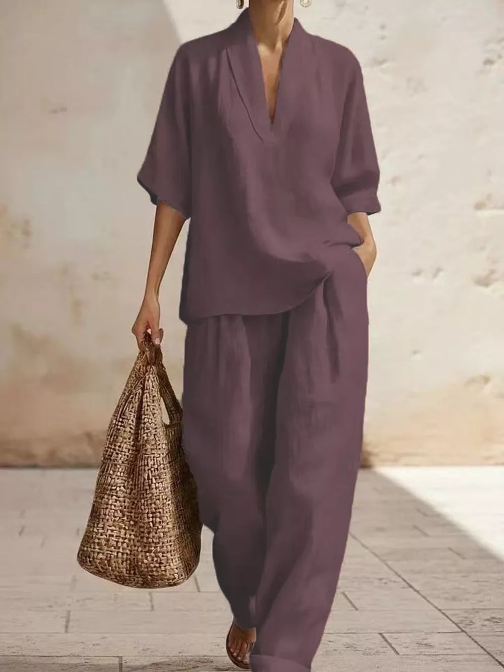 Mauve half-sleeve v-neck top and wide-leg pants set with pockets, styled with a woven tote bag.