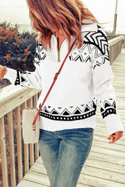 White geometric knit zip-neck pullover sweater with black pattern.