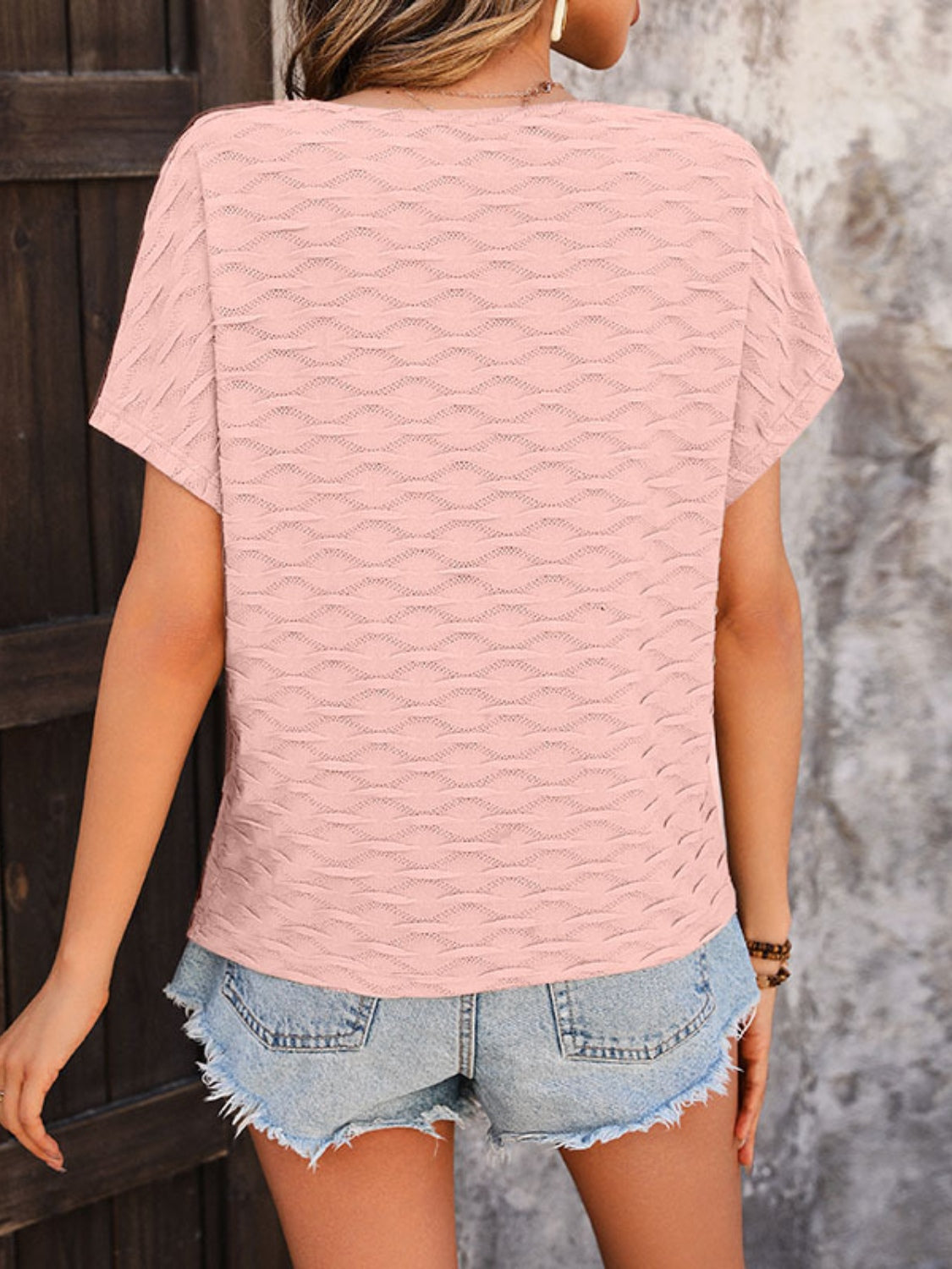Watermelon pink textured wave-patterned cap-sleeve blouse with a relaxed fit.