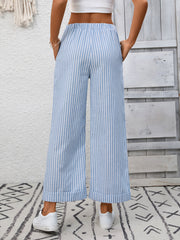 Light blue striped drawstring wide leg pants with pockets shown from the back.