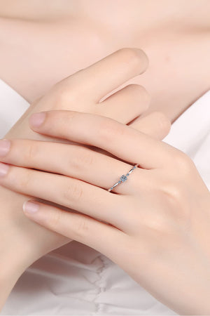 Delicate silver band ring with small diamonds and scalloped details.