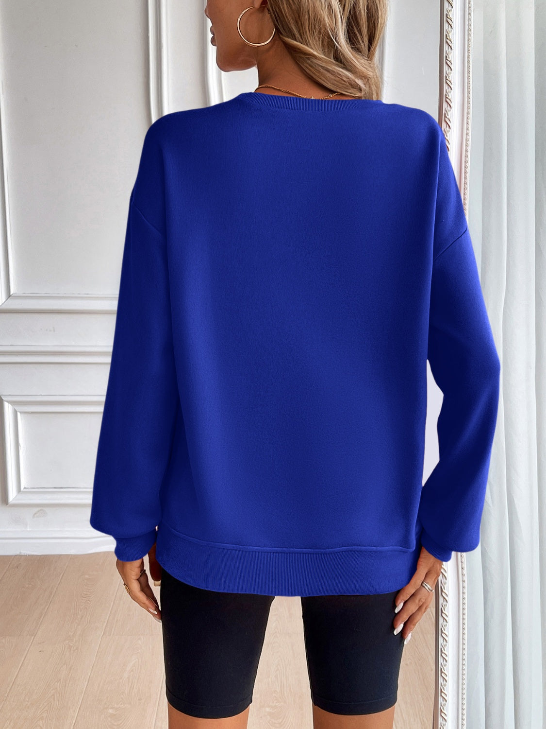 Relaxed fit royal blue crewneck sweatshirt with long sleeves and ribbed cuffs and hem.