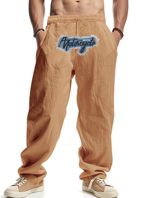 Khaki men's sweatpants with a motorcycle graphic and drawstring waist.