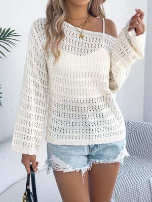 Ivory openwork knit sweater with bell sleeves and boatneck, styled with denim shorts.