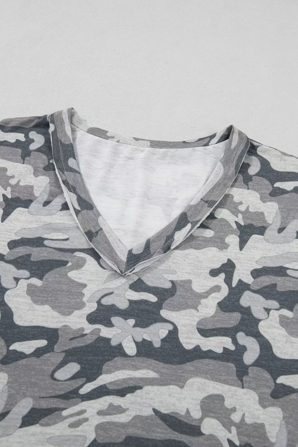 Grey camouflage V-neck relaxed tee with a soft cotton blend fabric.