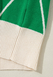 Dark green argyle knit sweater with cream ribbed trim and neckline detail.