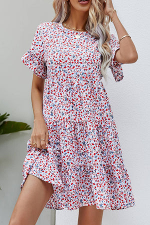 Miniature floral tiered babydoll dress with short flutter sleeves and round neckline.
