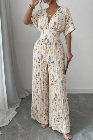 Floral pleated wide-leg maternity jumpsuit with a cinched waist and V-neck.