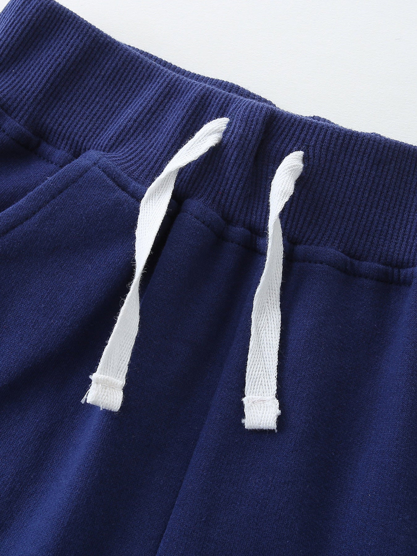 Boys' navy blue cotton shorts with drawstring waist and pockets.