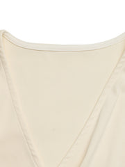 Cream surplice bodysuit with cap sleeves and a ribbed texture.
