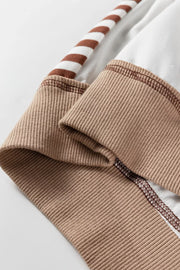 Beige sweatshirt detail with contrast stitching and striped sleeve cuff