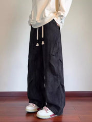 Black vintage wash utility cargo pants with drawstring waist and multiple pockets.