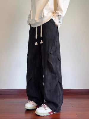 Black vintage wash utility cargo pants with drawstring waist and multiple pockets.