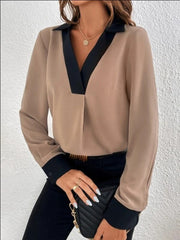 Camel and black contrast collar V-neck blouse with long sleeves.