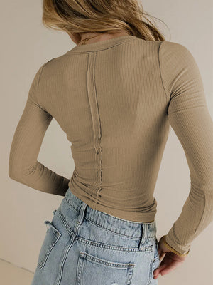 Tan ribbed long sleeve top with a V-neck and seam detail down the back.