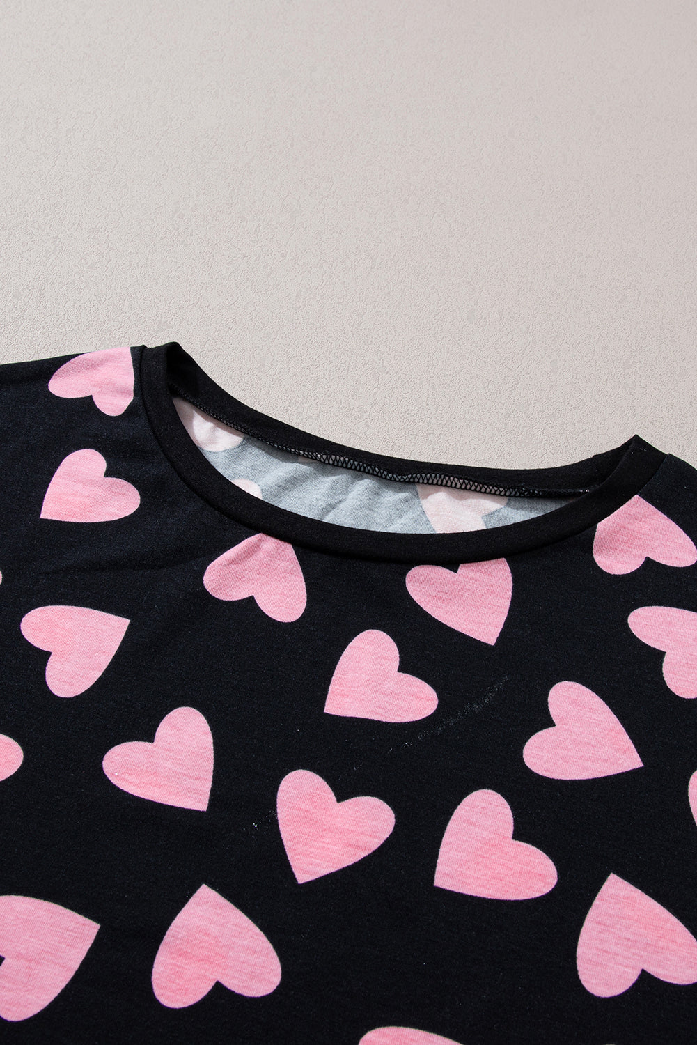 Black pajama top with pink heart print and crew neck