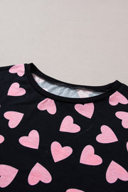 Black pajama top with pink heart print and crew neck