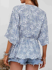 Light Blue abstract print cinched waist blouse with short sleeves and V-neck.