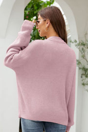Blush pink textured knit cardigan with oversized pockets and a collared neckline.