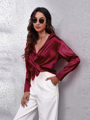 Burgundy silken button-down shirt with a knotted front and collared neckline.