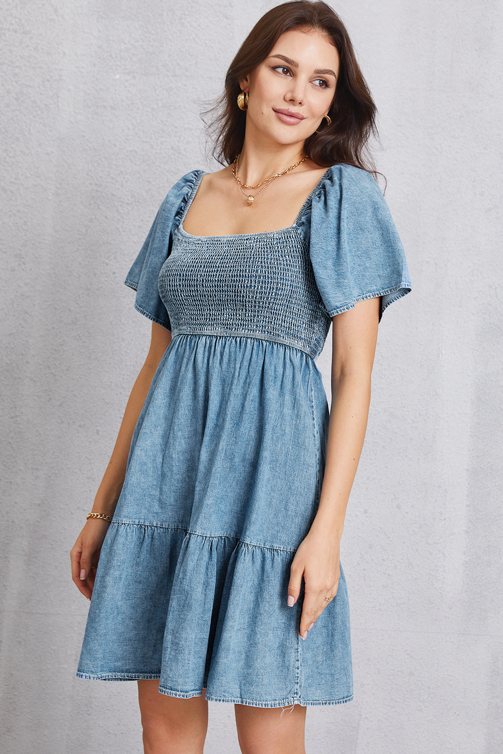 Denim puff sleeve prairie dress with smocked bodice and tiered skirt.