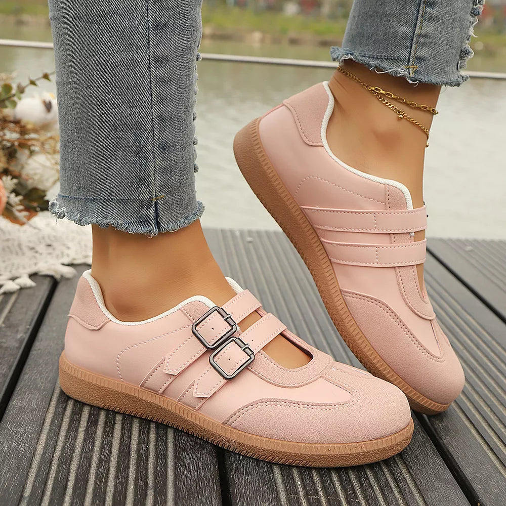 Pink buckle strap Mary Jane inspired sneakers with double buckle detail and suede accents.