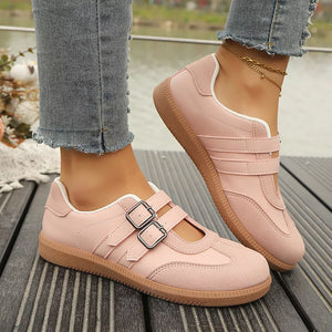 Pink buckle strap Mary Jane inspired sneakers with double buckle detail and suede accents.
